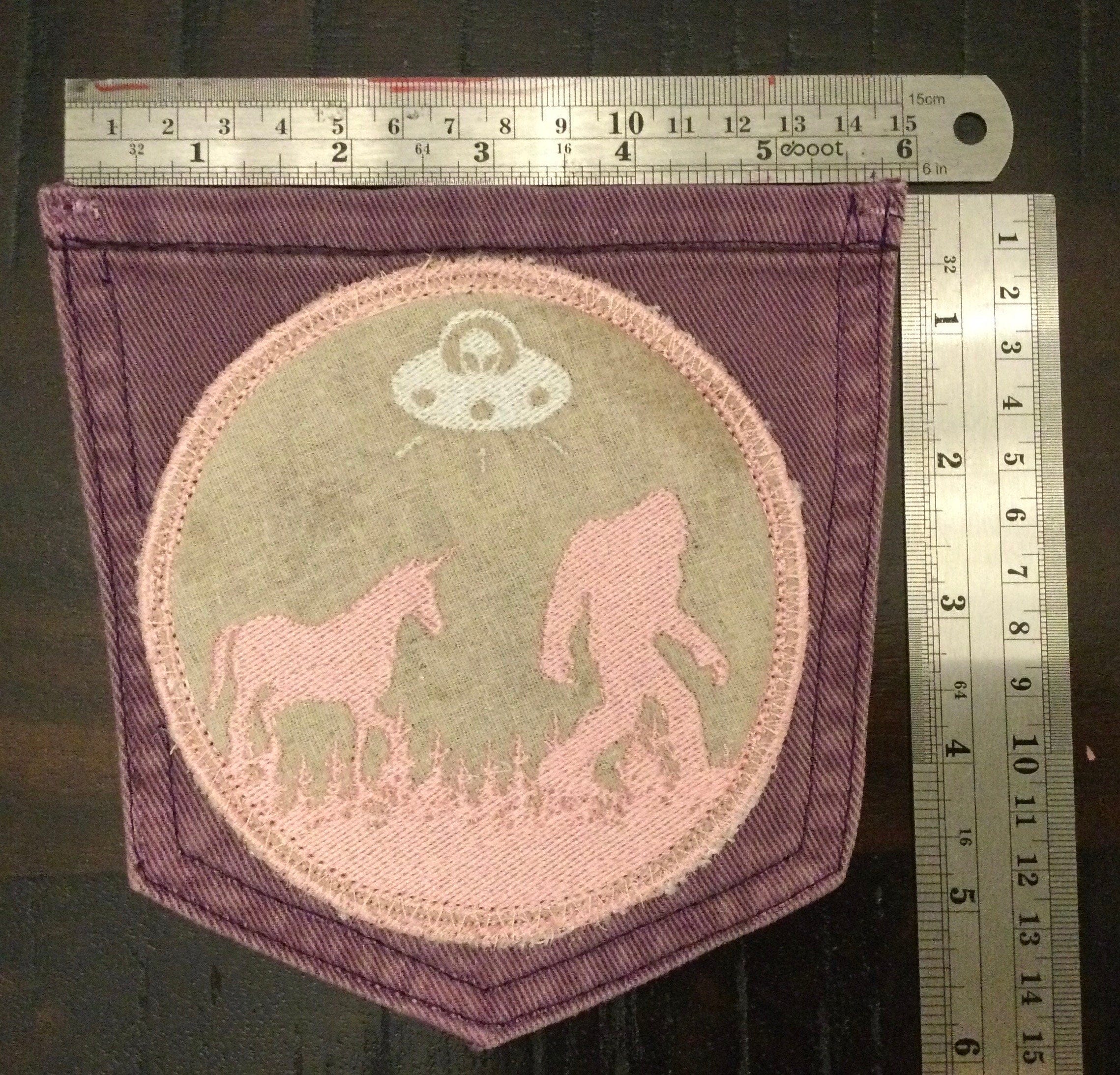 Hot Pocket BELIEVE Purple Pocket Denim Patch BIGFOOT Unicorn UFO pink and silver on wheat background Appliques & Patches